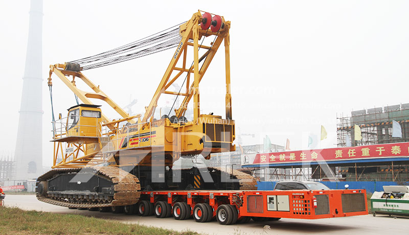 Another similar case shows SPMT system carries heavy crawler machine on the road