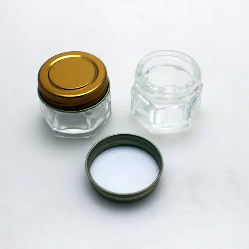 Frasco hexagonal transparente con tapa de metal frasco de vidrio para crema cosmética