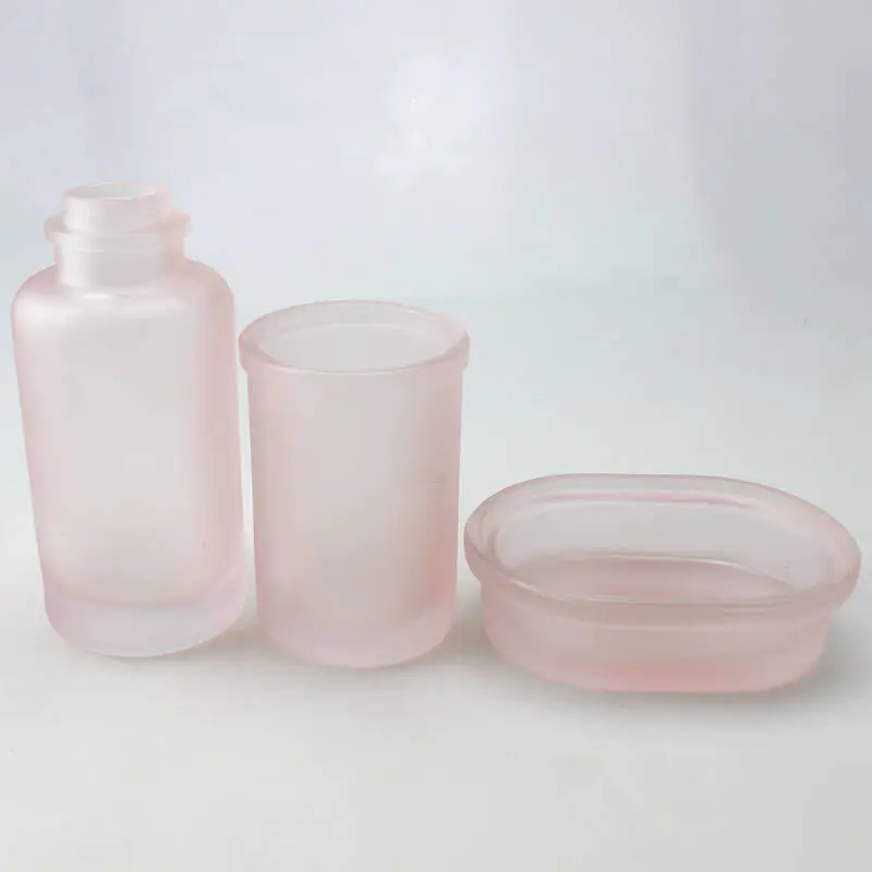曇ったピンクの浴室の付属品は4つの部分、入浴の塩のガラス瓶、シャンプーポンプのびん、ガラスの石鹸皿をセットする