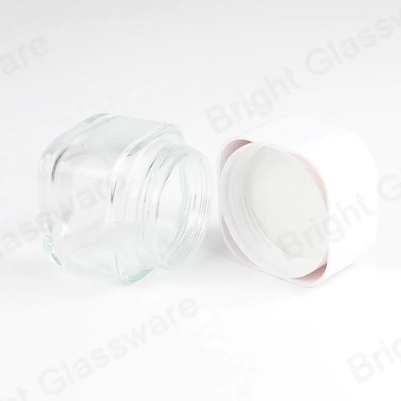白いふたが付いている卸し売りの透明な正方形のガラス化粧品の瓶